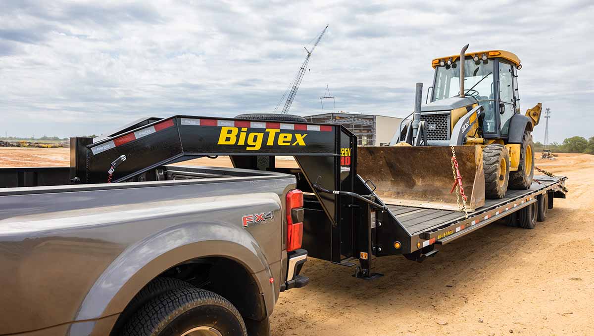22GN Flatbed Gooseneck Trailer Transporting Construction Vehicle